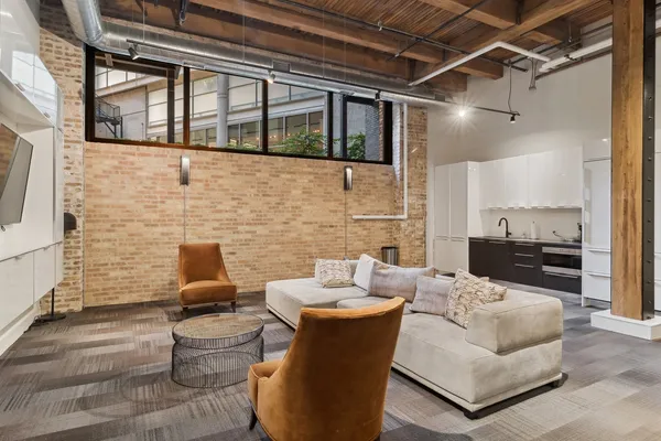 a living room with patio furniture and a fireplace