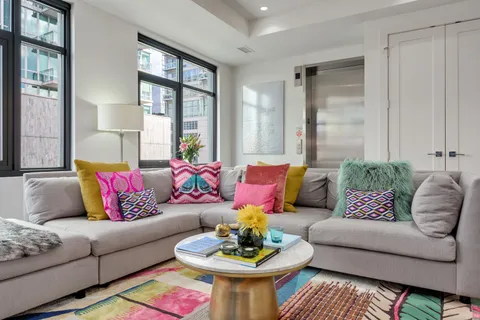 a living room with furniture and a large window