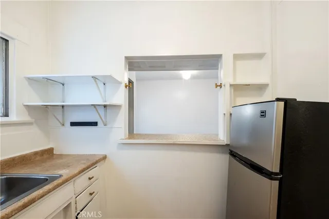 a kitchen with a refrigerator and a sink