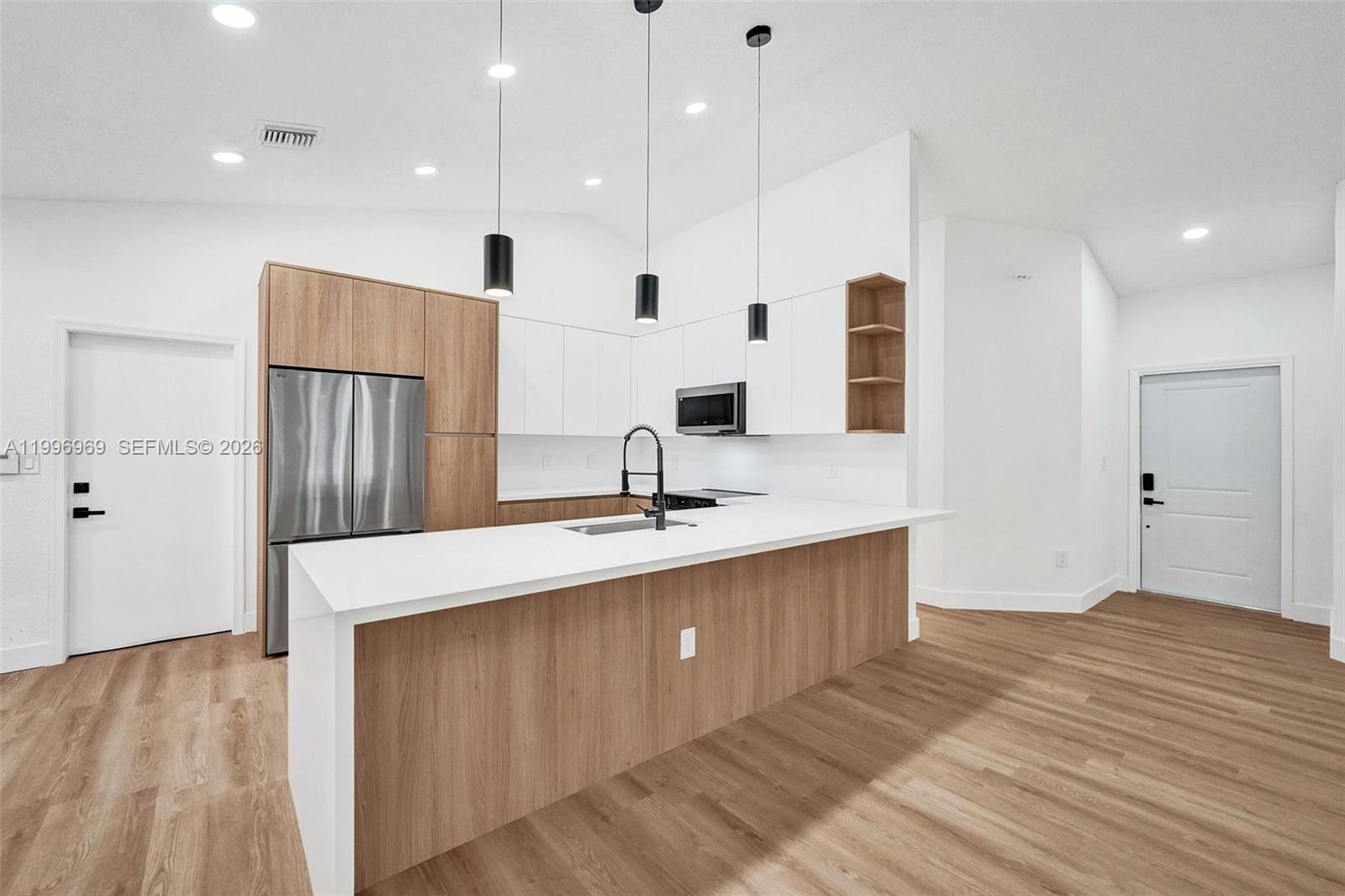 10153 Northwest 3rd Court Plantation, FL 33324 - Photo 16 of 82 a large kitchen with kitchen island a sink stainless steel appliances and cabinets