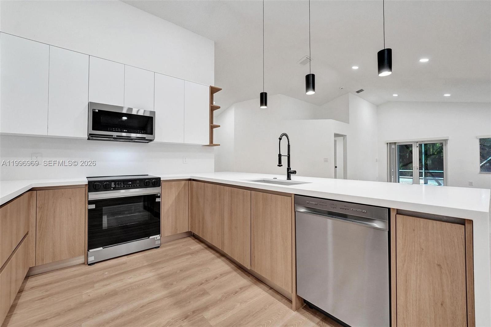 10153 Northwest 3rd Court Plantation, FL 33324 - Photo 22 of 82 a kitchen with stainless steel appliances a stove sink and microwave