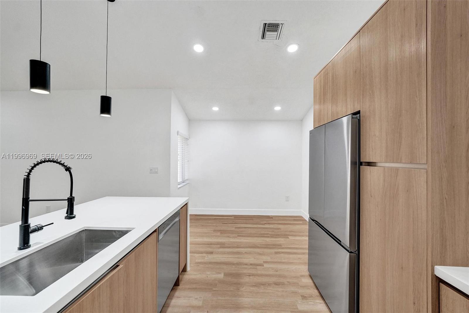 10153 Northwest 3rd Court Plantation, FL 33324 - Photo 24 of 82 a kitchen with kitchen island stainless steel appliances a sink and a refrigerator