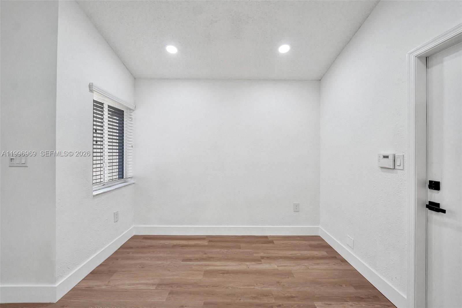 10153 Northwest 3rd Court Plantation, FL 33324 - Photo 26 of 82 a view of an empty room with wooden floor and a window