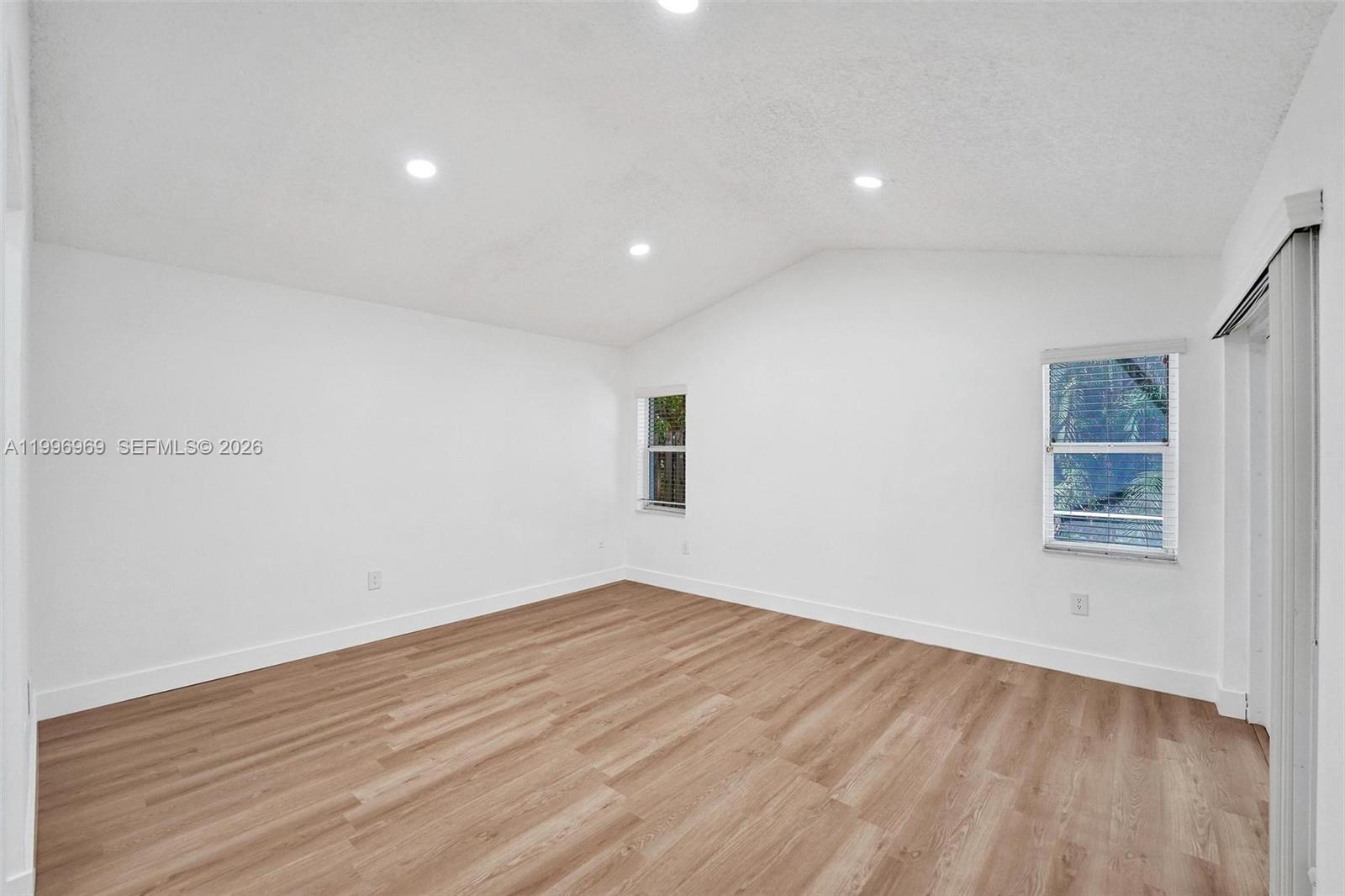 10153 Northwest 3rd Court Plantation, FL 33324 - Photo 39 of 82 a view of empty room with wooden floor and fan