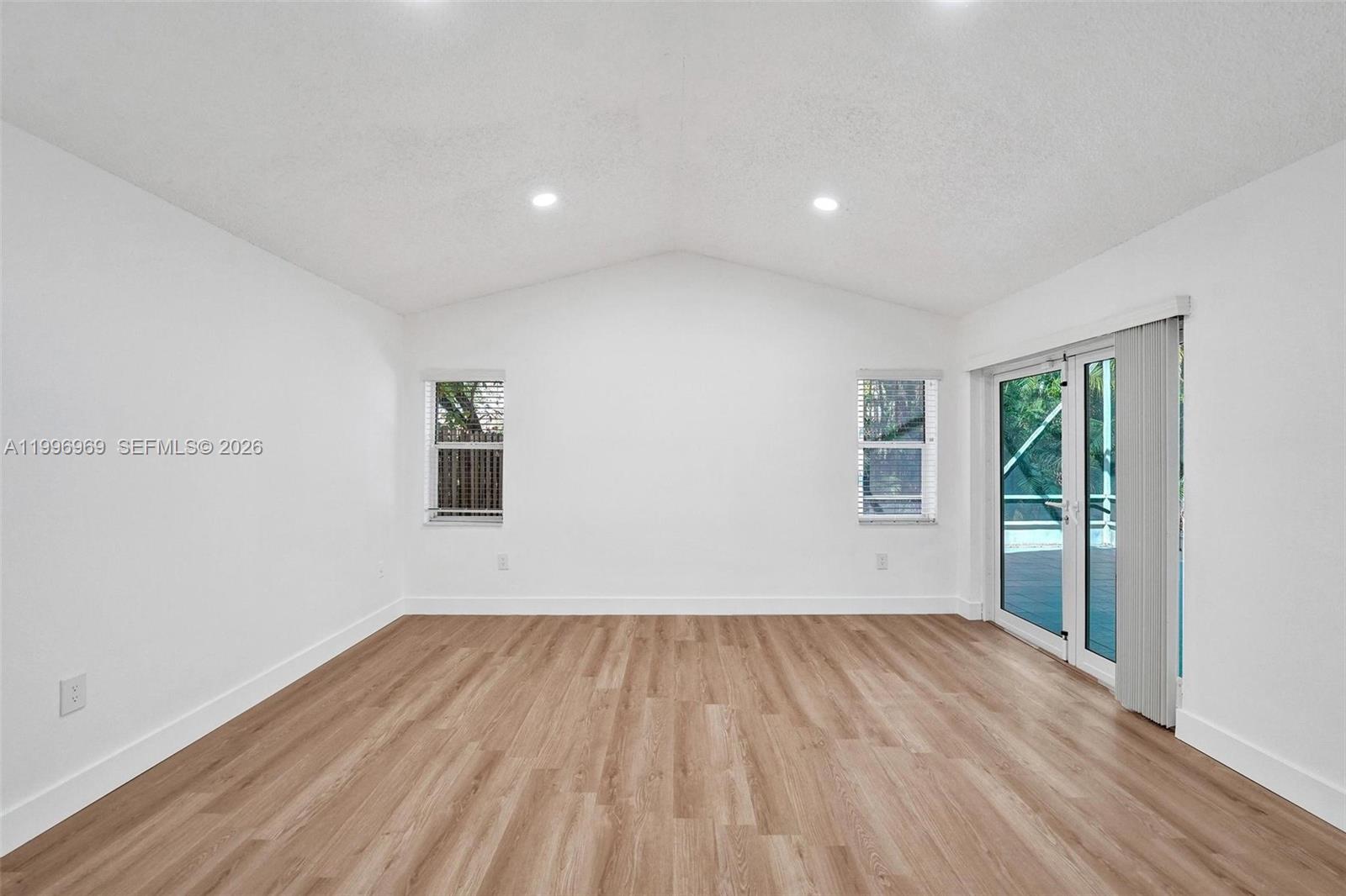 10153 Northwest 3rd Court Plantation, FL 33324 - Photo 40 of 82 a view of empty room with wooden floor and fan