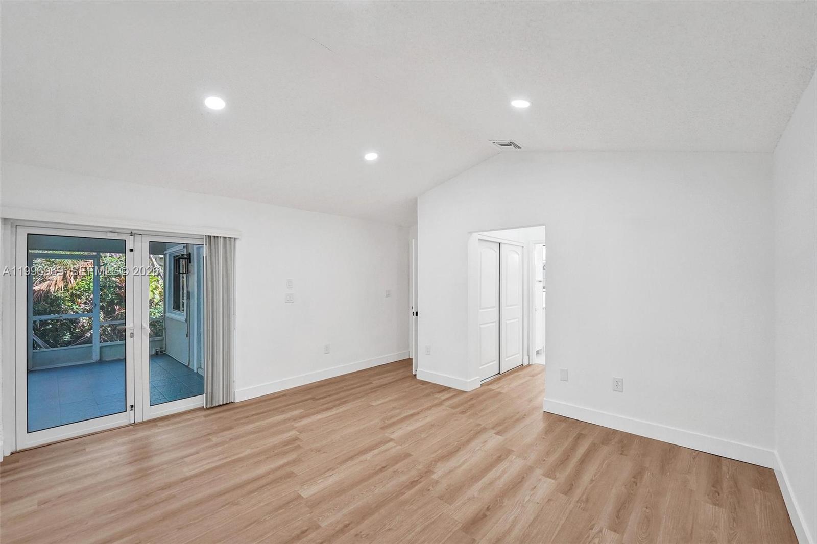 10153 Northwest 3rd Court Plantation, FL 33324 - Photo 44 of 82 an empty room with wooden floor and windows