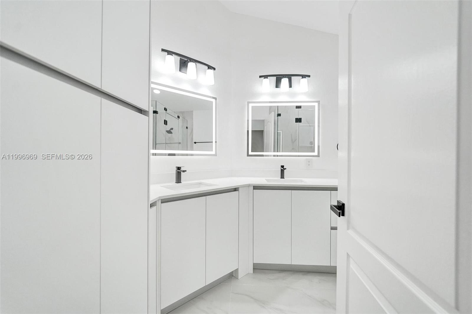 10153 Northwest 3rd Court Plantation, FL 33324 - Photo 48 of 82 a spacious bathroom with a sink and a mirror