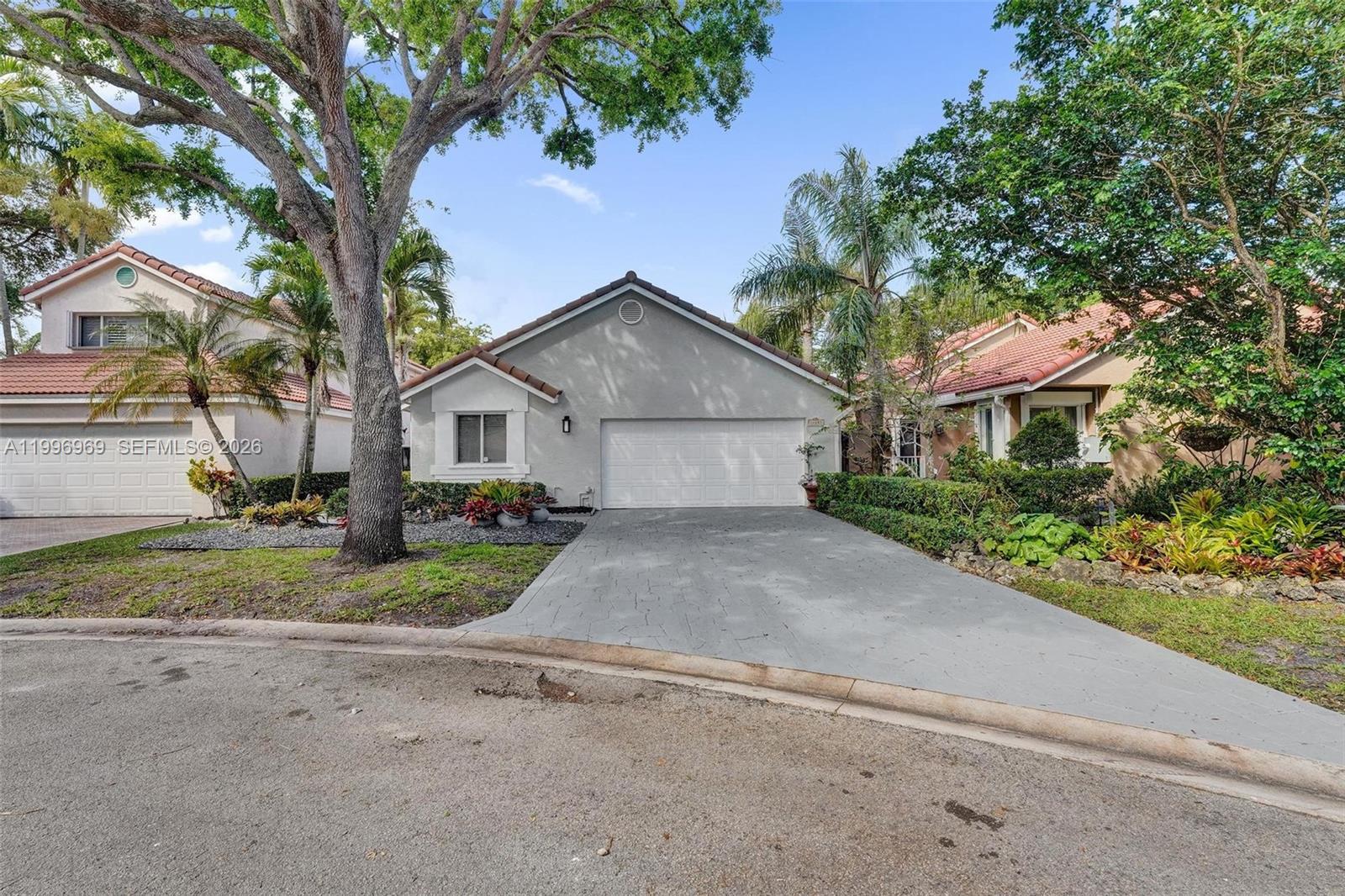 10153 Northwest 3rd Court Plantation, FL 33324 - Photo 5 of 82 a view of a house with a yard and large tree