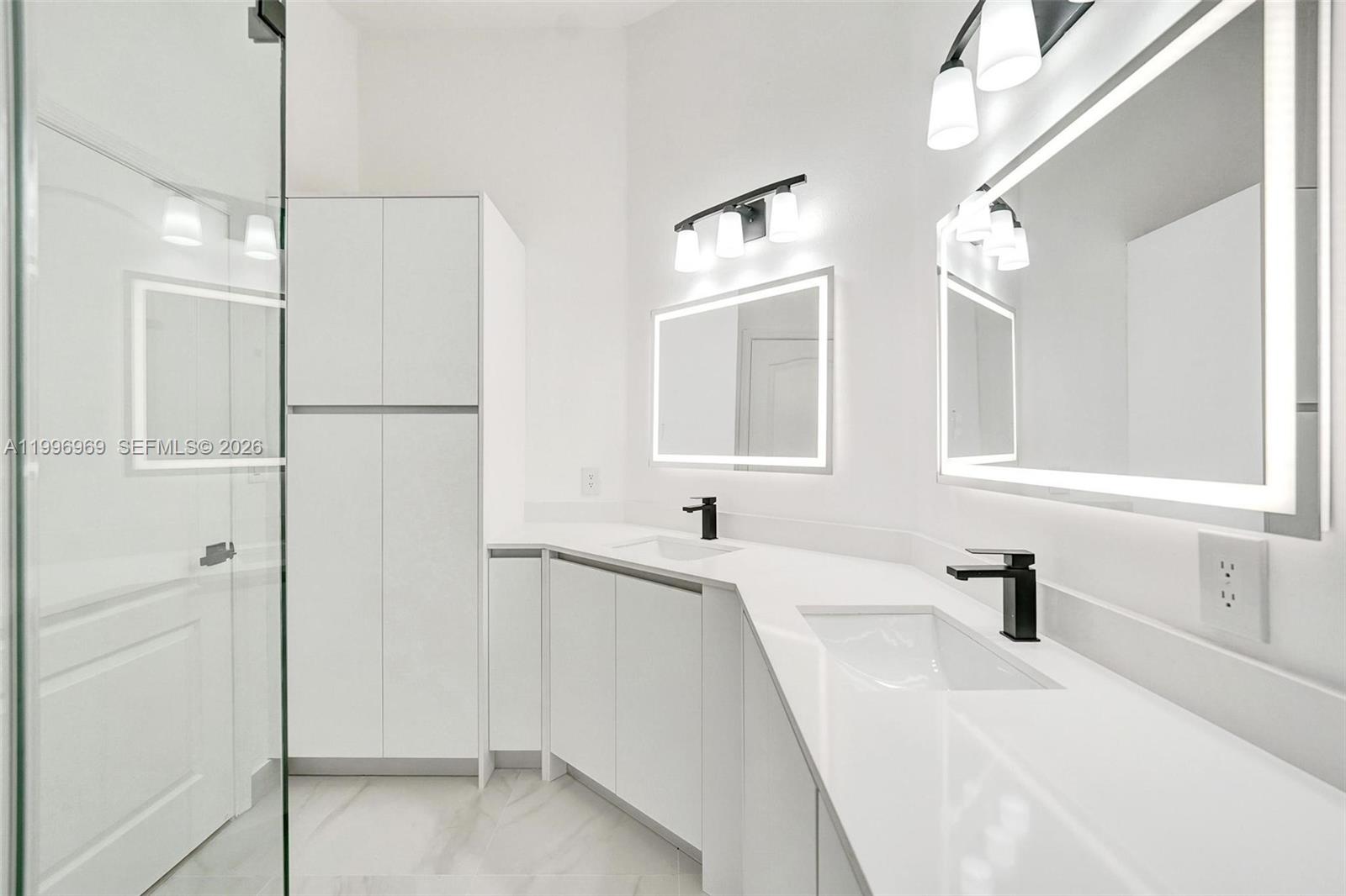 10153 Northwest 3rd Court Plantation, FL 33324 - Photo 54 of 82 a bathroom with a sink a mirror and a shower