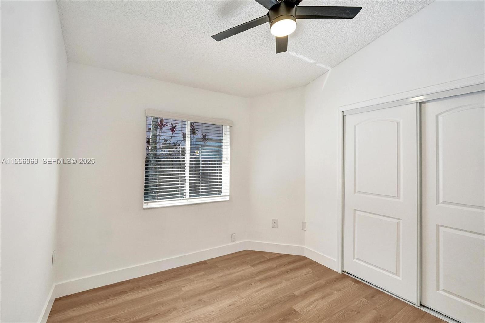 10153 Northwest 3rd Court Plantation, FL 33324 - Photo 57 of 82 an empty room with a window and a ceiling fan