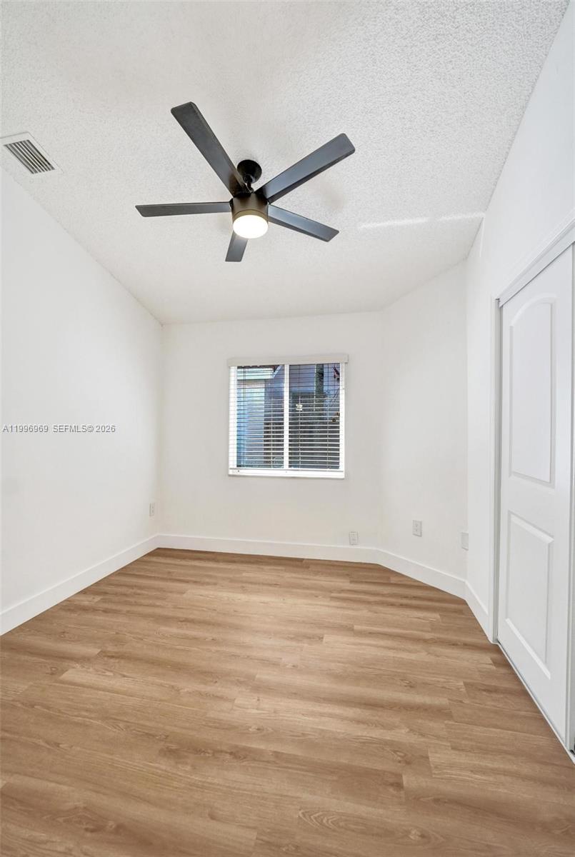 10153 Northwest 3rd Court Plantation, FL 33324 - Photo 59 of 82 a view of empty room with wooden floor and fan