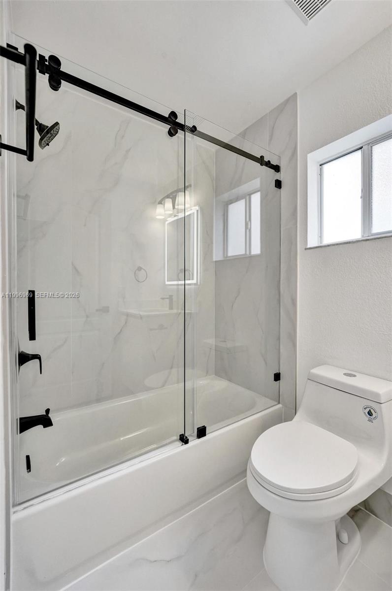 10153 Northwest 3rd Court Plantation, FL 33324 - Photo 63 of 82 a bathroom with a toilet and shower