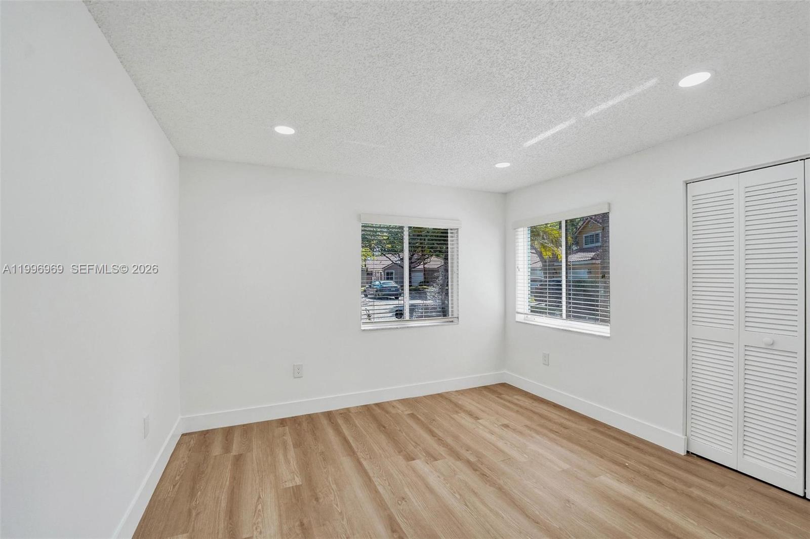 10153 Northwest 3rd Court Plantation, FL 33324 - Photo 64 of 82 an empty room with wooden floor and windows