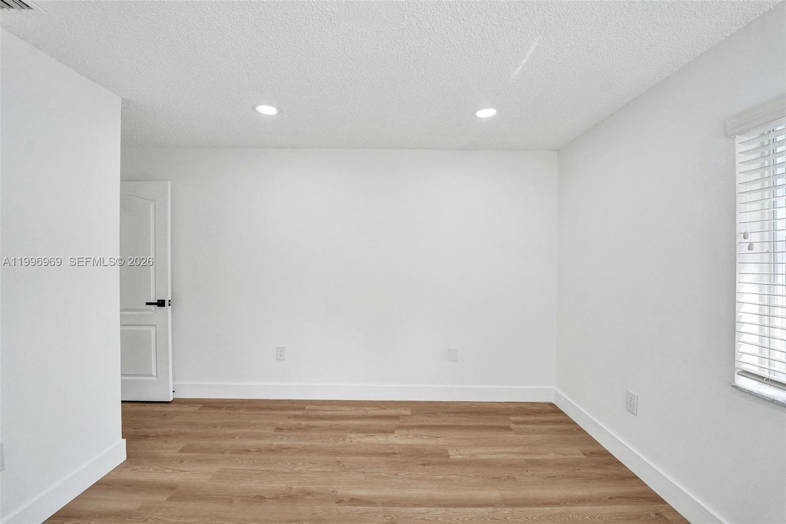 10153 Northwest 3rd Court Plantation, FL 33324 - Photo 66 of 82 a view of an empty room with wooden floor and a window