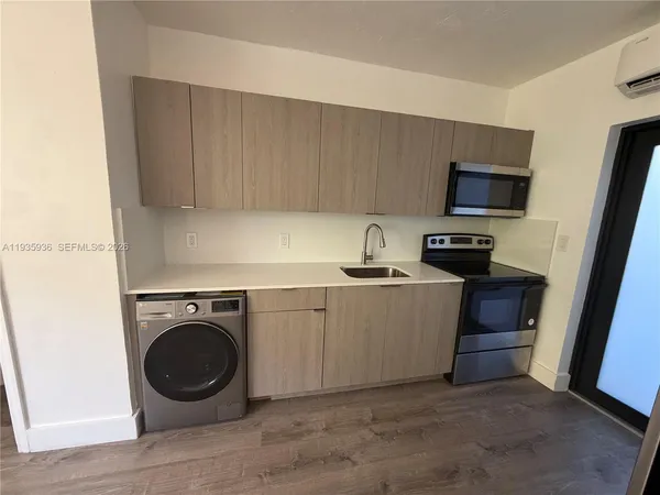 a view of a kitchen with washer and dryer