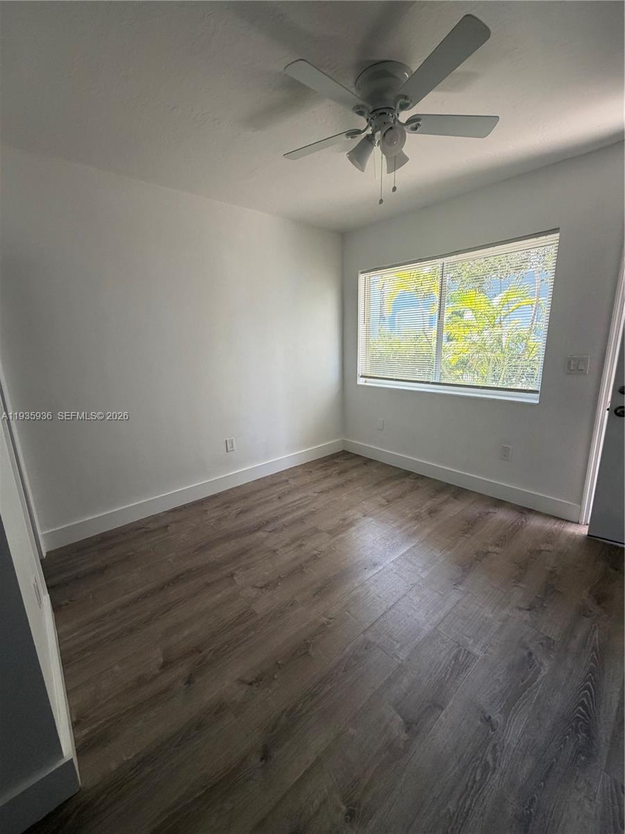 201 Southwest 21st Court, Unit 2 Miami, FL 33135 - Photo 3 of 5 an empty room with wooden floor and windows