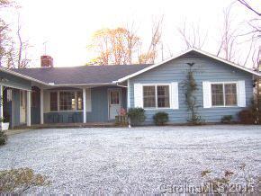 69 Eargle Road Tryon, NC 28782 - Photo 1 of 4 a front view of a house with a yard