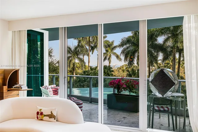 a living room with couch and a potted plant