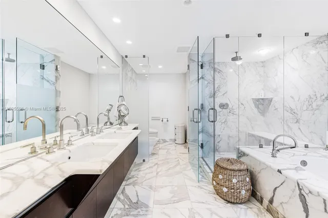 a spacious bathroom with a double vanity sink mirror and shower