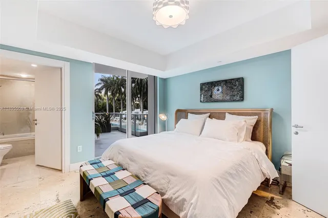 a bedroom with a bed and a large mirror