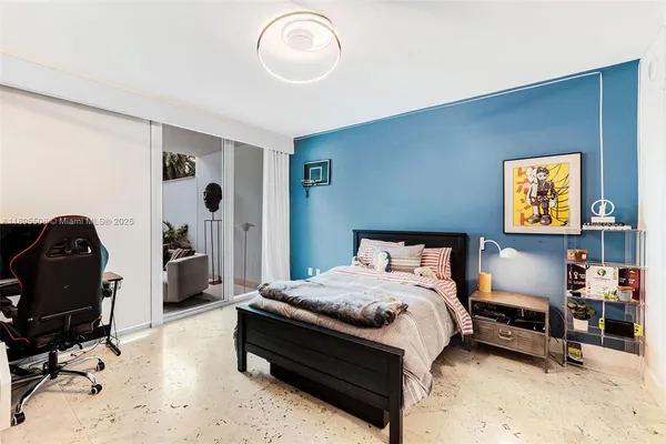 a bedroom with a bed and cabinets