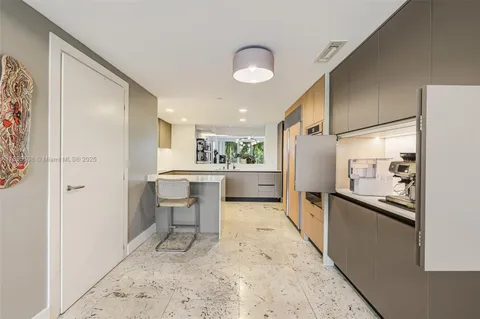 a kitchen with a refrigerator and a sink