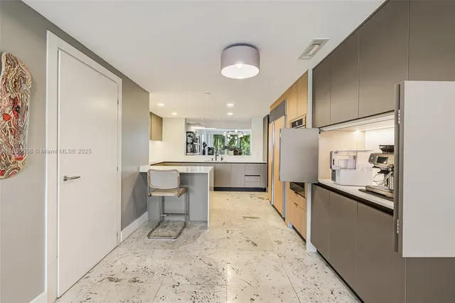 a kitchen with a refrigerator and a sink