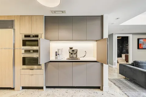 a kitchen with stainless steel appliances granite countertop a refrigerator and a stove top oven