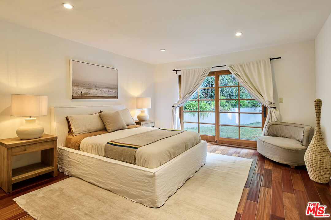 3268 Serra Road Malibu, CA 90265 - Photo 18 of 24 a spacious bedroom with a large bed and a large window