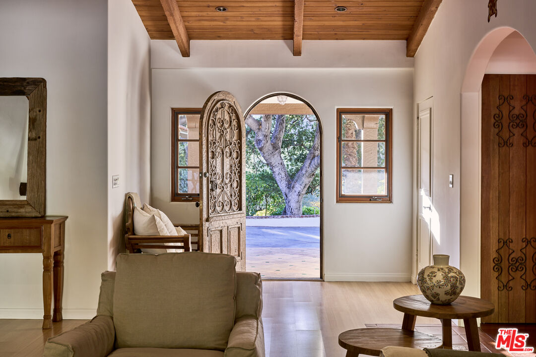 3268 Serra Road Malibu, CA 90265 - Photo 5 of 24 a living room with furniture and large windows