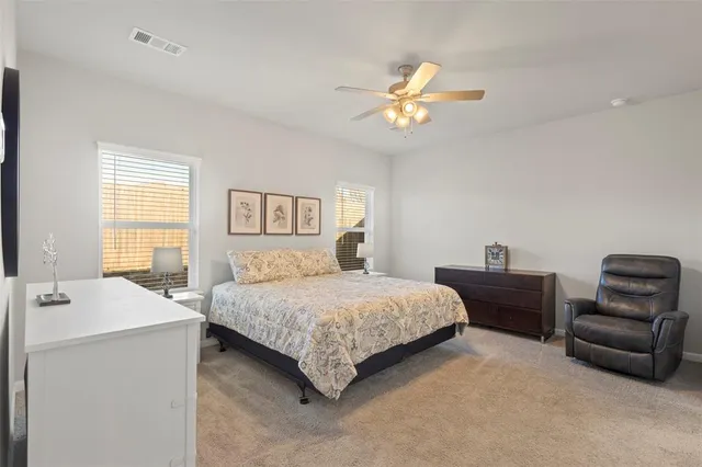 a bedroom with a bed and a couch