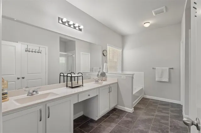 a bathroom with double sink and a mirror