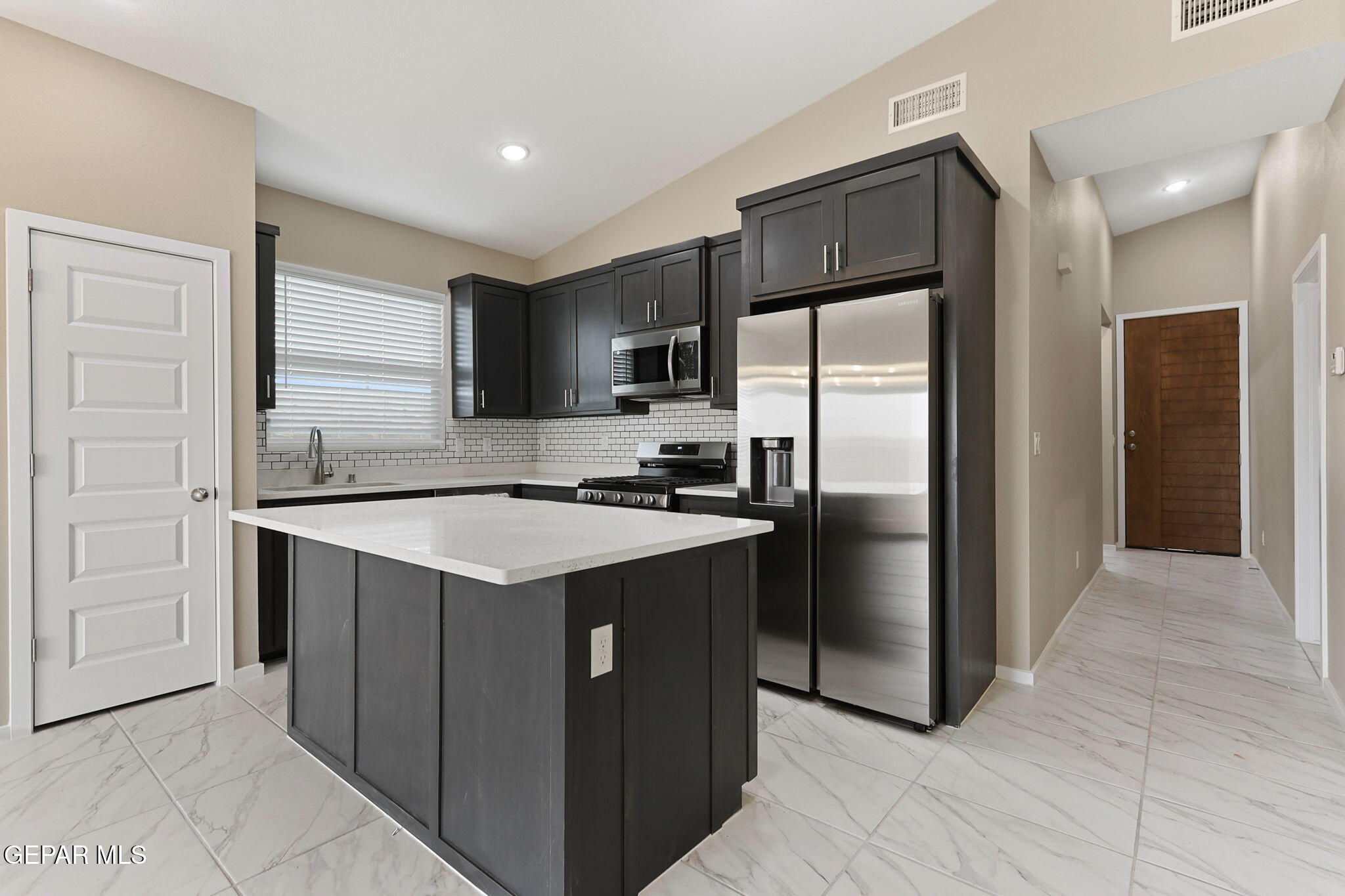 8420 Fish Place Vinton, TX 79821 - Photo 12 of 20 a kitchen with stainless steel appliances granite countertop a refrigerator stove and sink