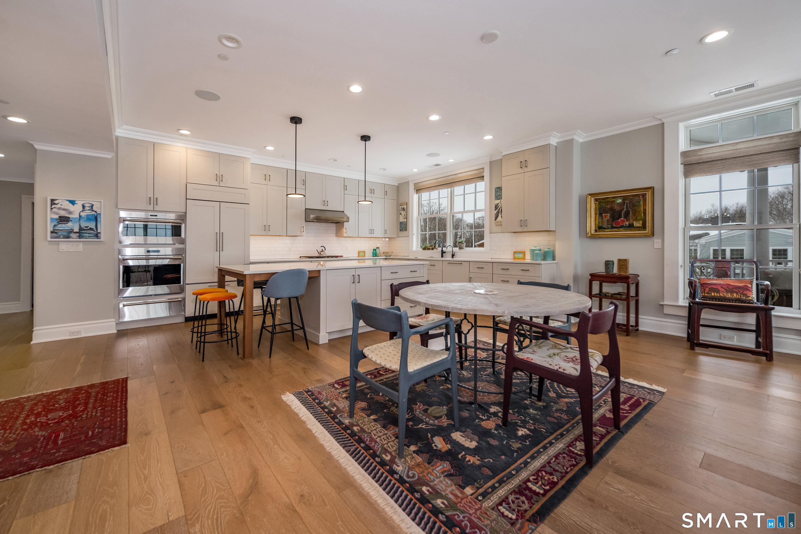 66 High Street, Unit 34 Guilford, CT 06437 - Photo 14 of 40 a dining hall with stainless steel appliances granite countertop a table and chairs