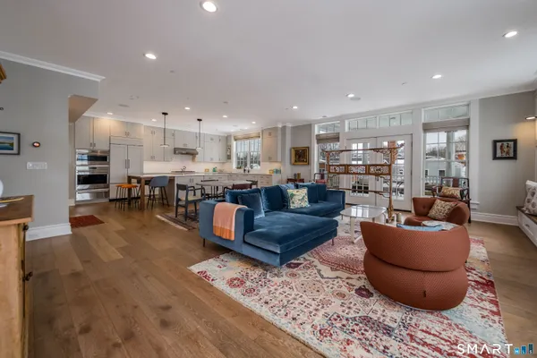 a living room with furniture and a wooden floor