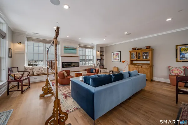 a living room with patio furniture and a potted plants