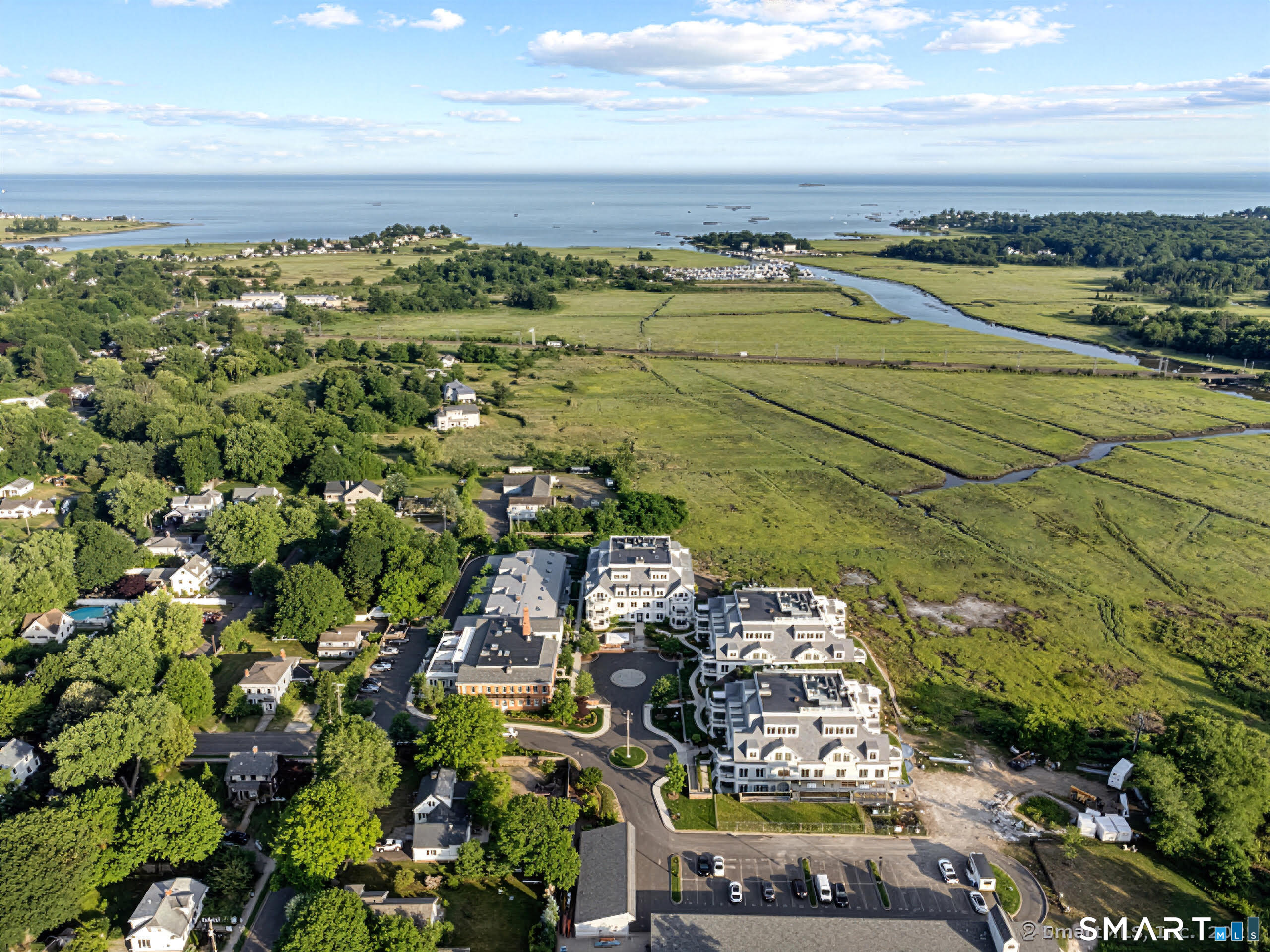 66 High Street, Unit 34 Guilford, CT 06437 - Photo 2 of 40 a view of a city with an ocean