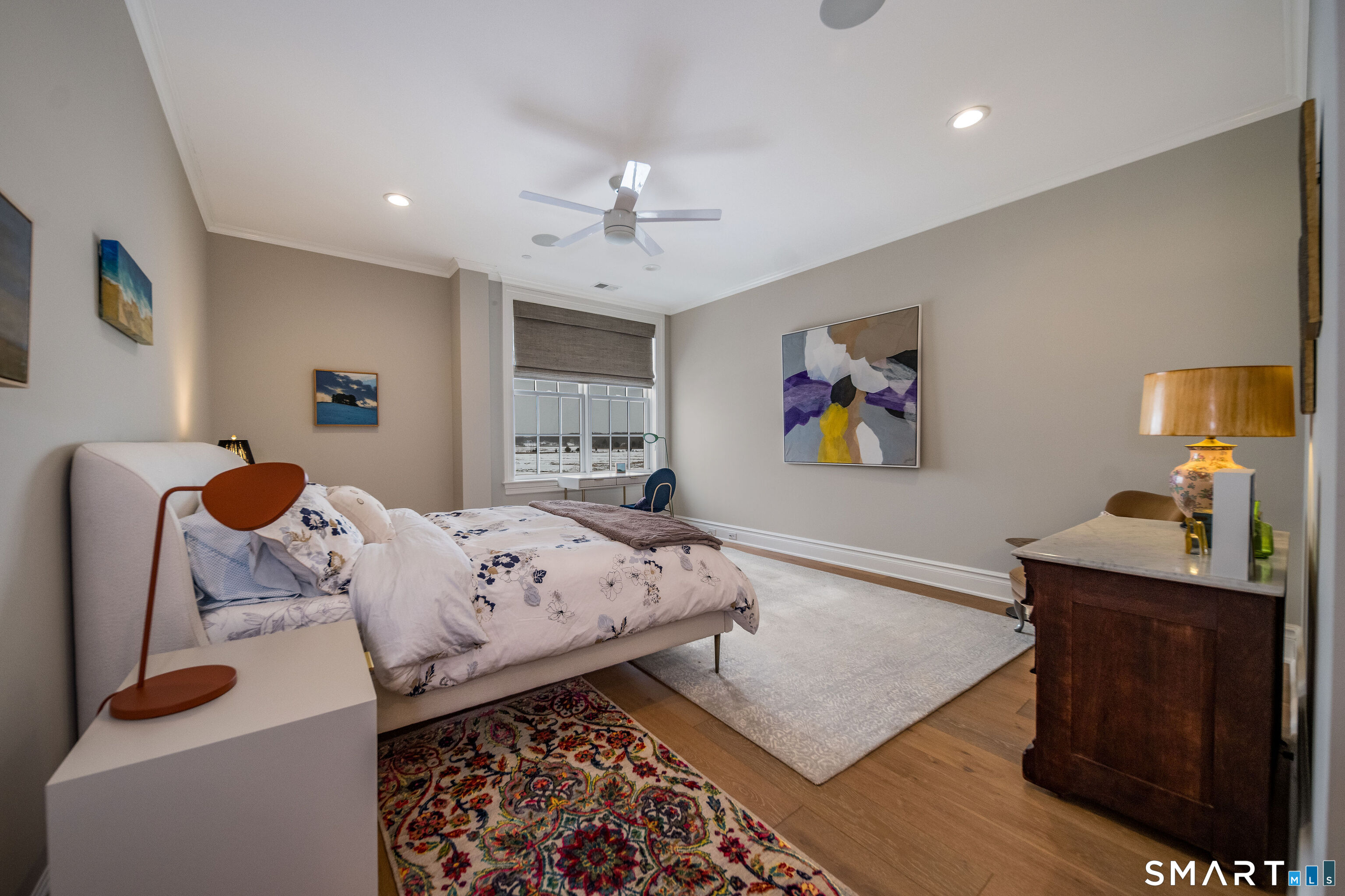 66 High Street, Unit 34 Guilford, CT 06437 - Photo 23 of 40 a bed room with a bed and a lamp