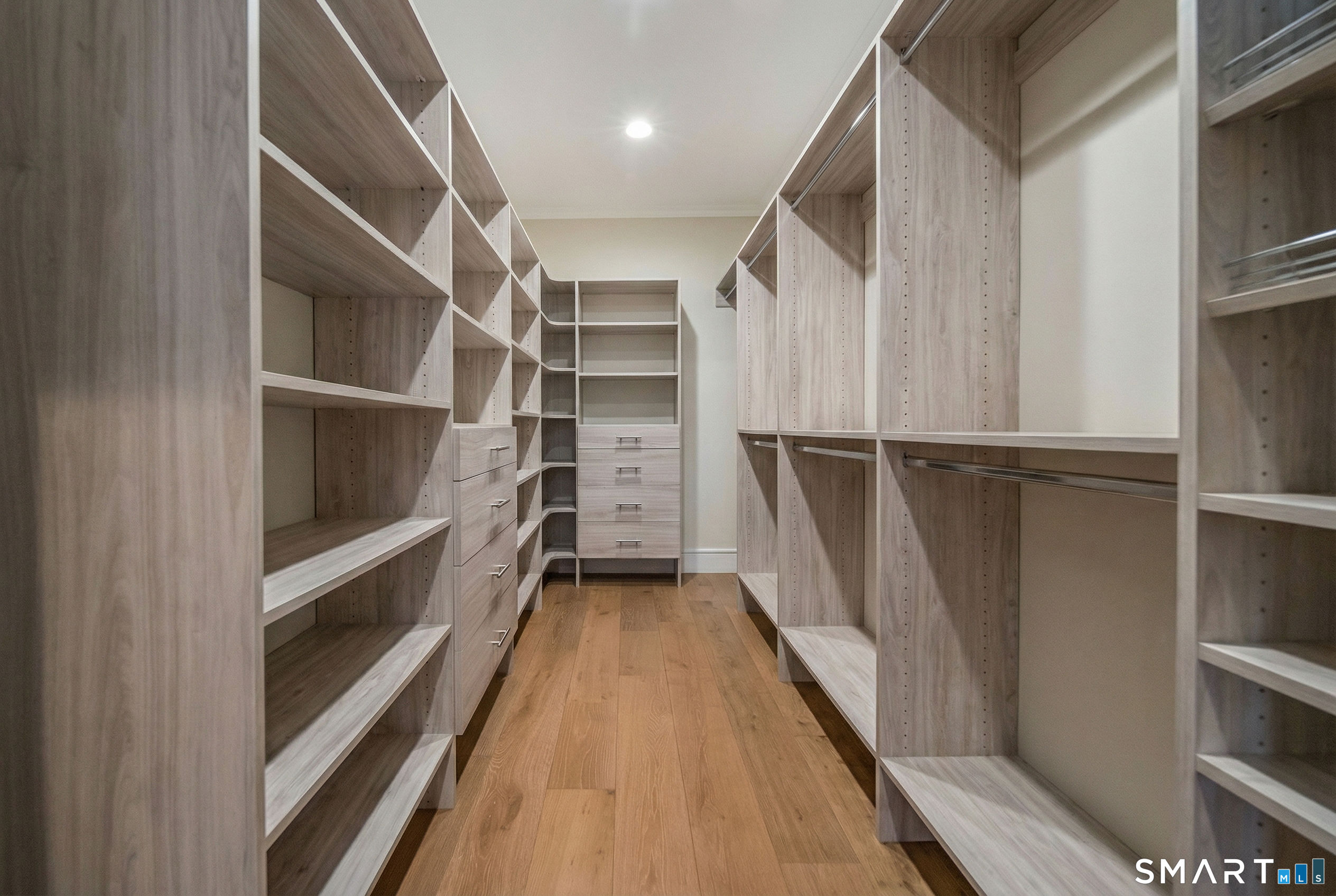 66 High Street, Unit 34 Guilford, CT 06437 - Photo 27 of 40 a view of walk in closet with empty racks