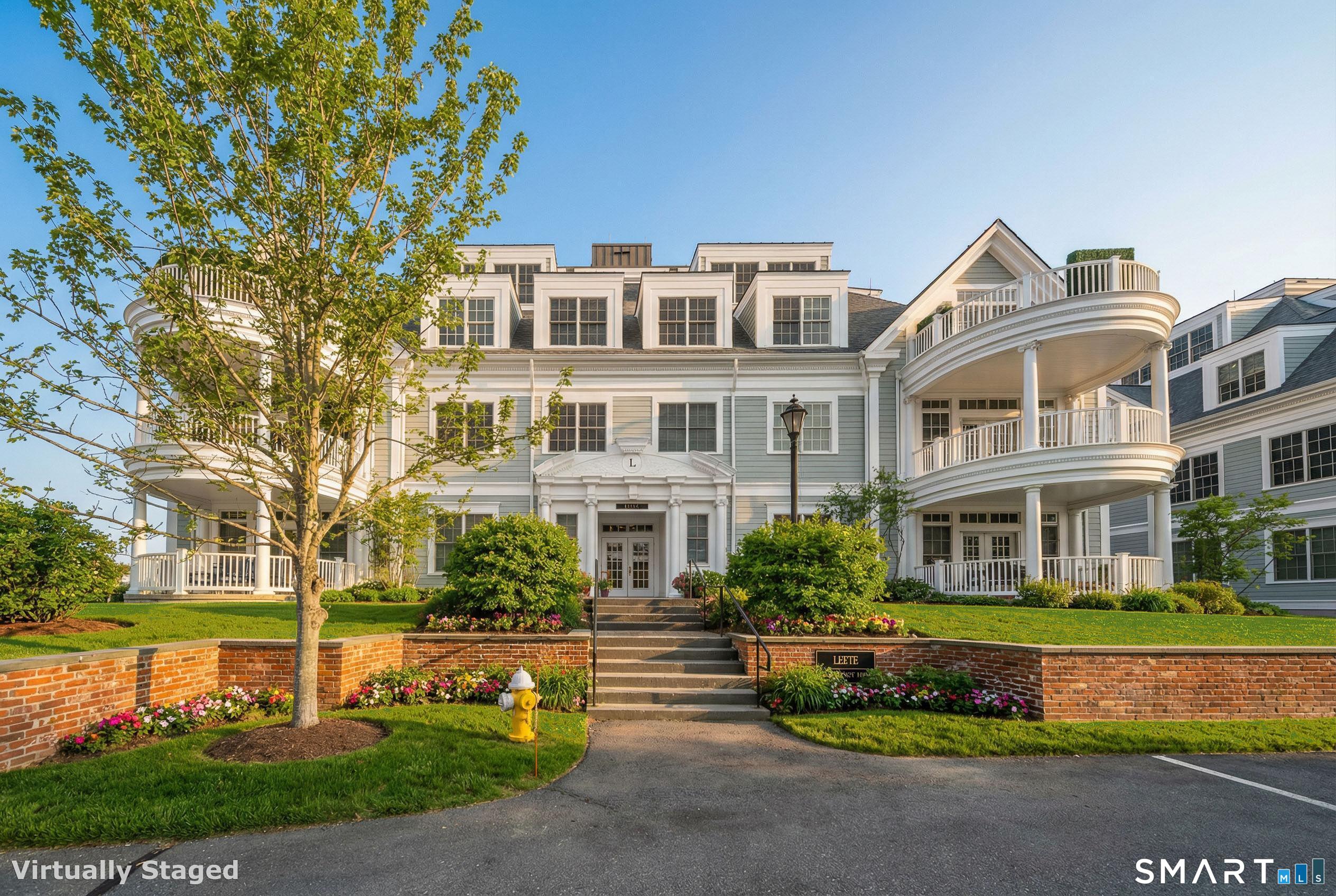 66 High Street, Unit 34 Guilford, CT 06437 - Photo 4 of 39 Virtually staged photo showing the Leete Building entrance in the Spring.