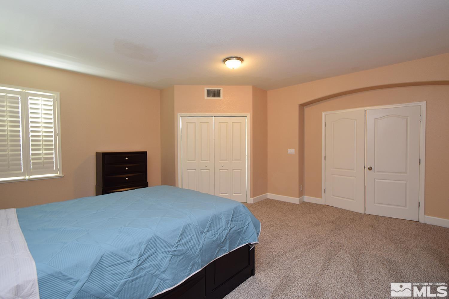 410 Teramo Court Reno, NV 89521 - Photo 11 of 32 a bedroom with a bed and a window