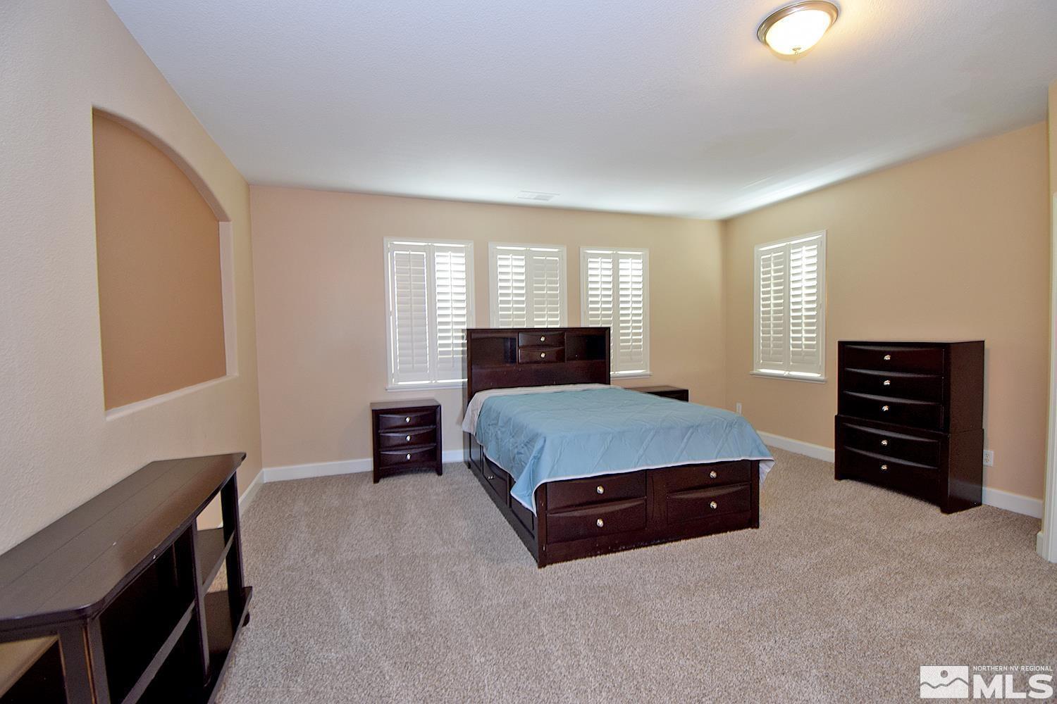 410 Teramo Court Reno, NV 89521 - Photo 12 of 32 a living room with furniture and a flat screen tv