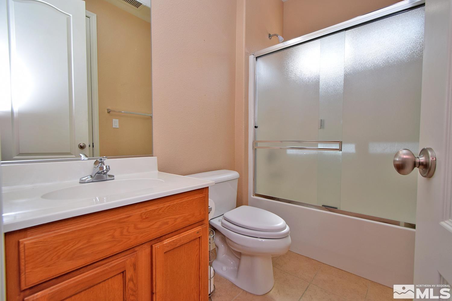 410 Teramo Court Reno, NV 89521 - Photo 13 of 32 a bathroom with a sink a toilet and shower
