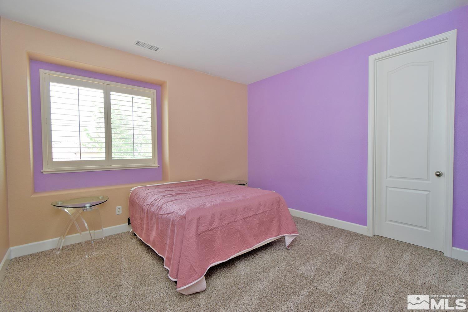 410 Teramo Court Reno, NV 89521 - Photo 19 of 32 a bedroom with a bed and a window