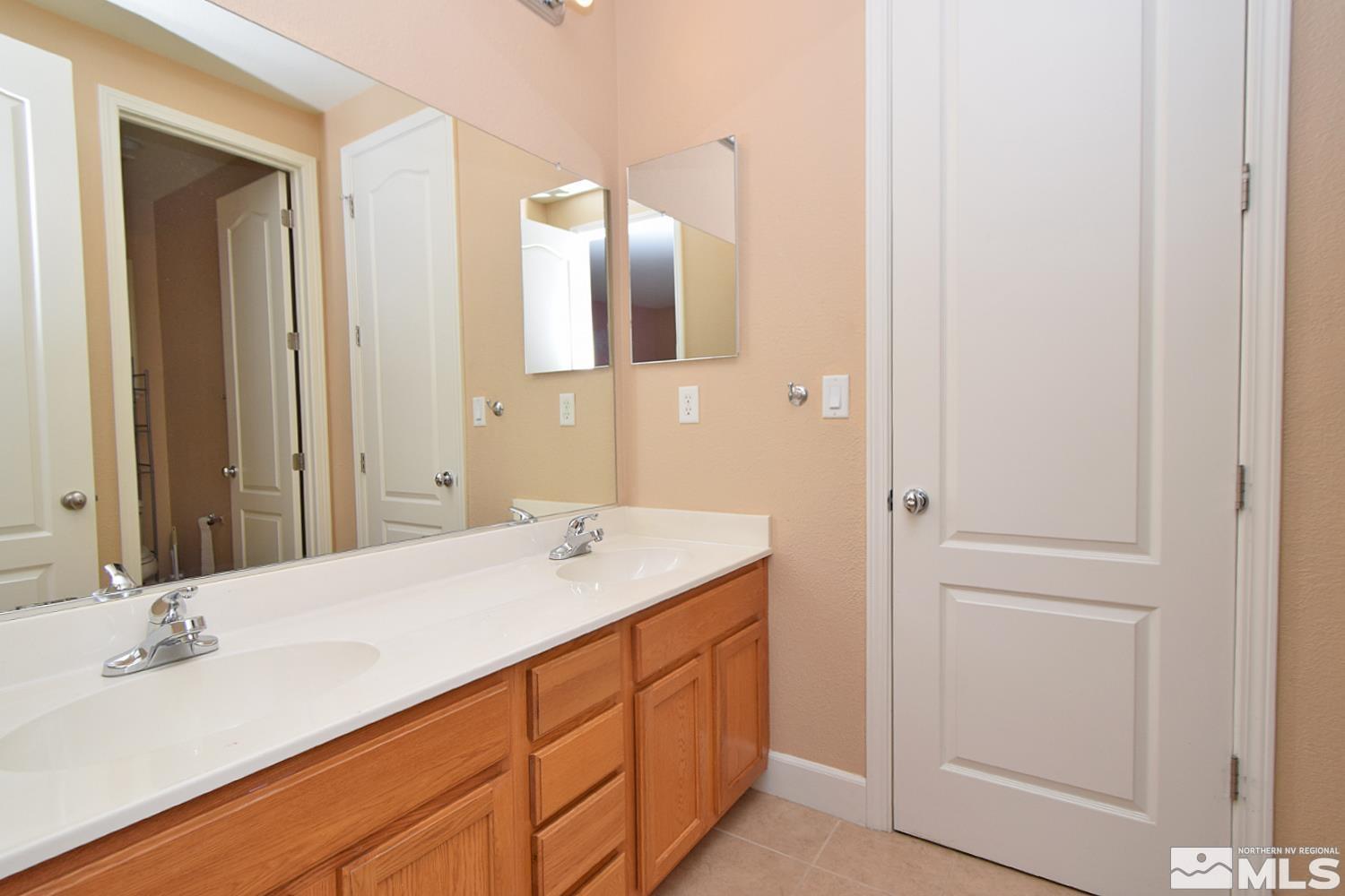 410 Teramo Court Reno, NV 89521 - Photo 20 of 32 a bathroom with a sink and a mirror