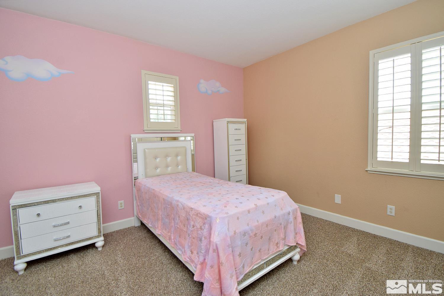 410 Teramo Court Reno, NV 89521 - Photo 21 of 32 a bedroom with a bed and a dresser