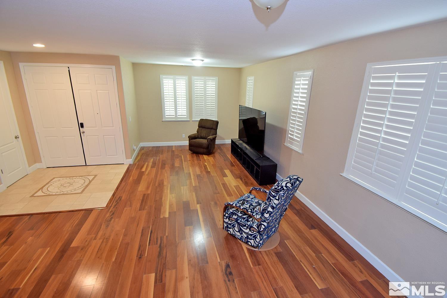 410 Teramo Court Reno, NV 89521 - Photo 23 of 32 a living room with furniture and a flat screen tv