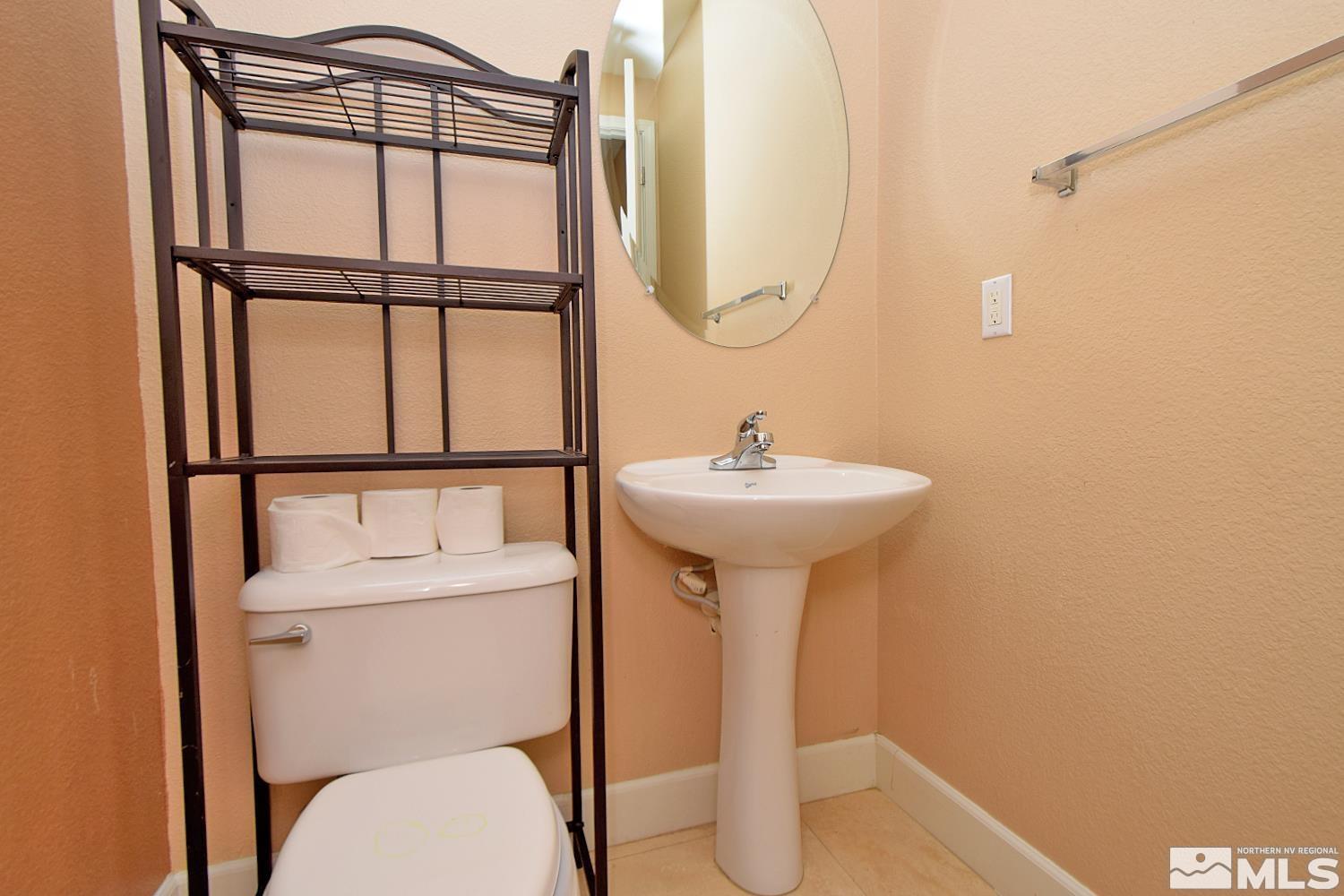 410 Teramo Court Reno, NV 89521 - Photo 28 of 32 a bathroom with a sink toilet and a mirror