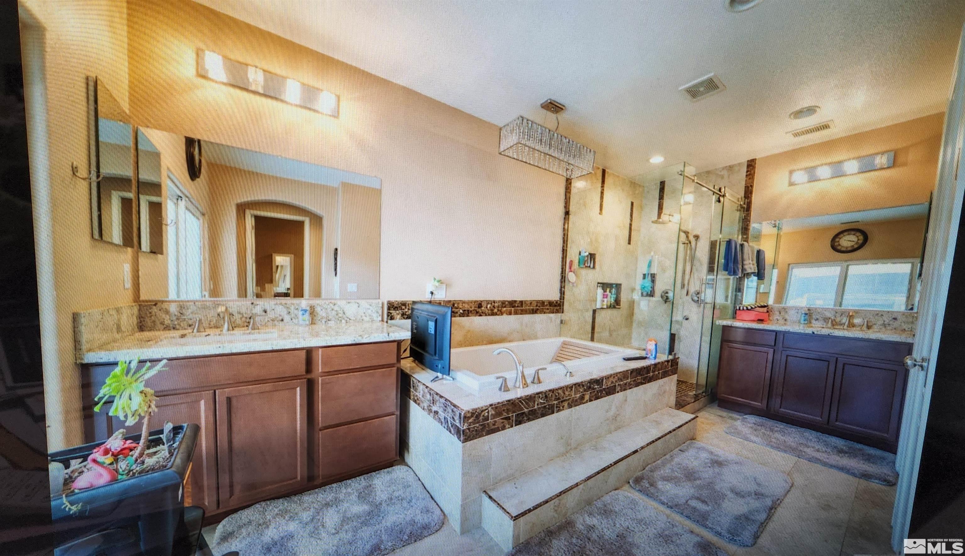 410 Teramo Court Reno, NV 89521 - Photo 3 of 32 a large spacious bathroom with a granite countertop tub and a mirror