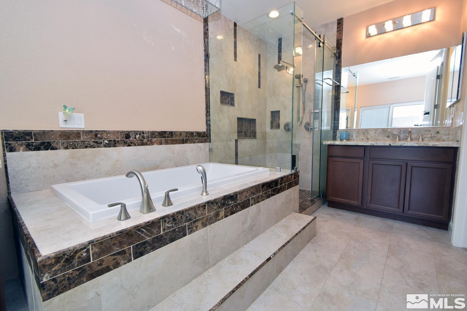 410 Teramo Court Reno, NV 89521 - Photo 5 of 32 a spacious bathroom with a bathtub shower sink and mirror